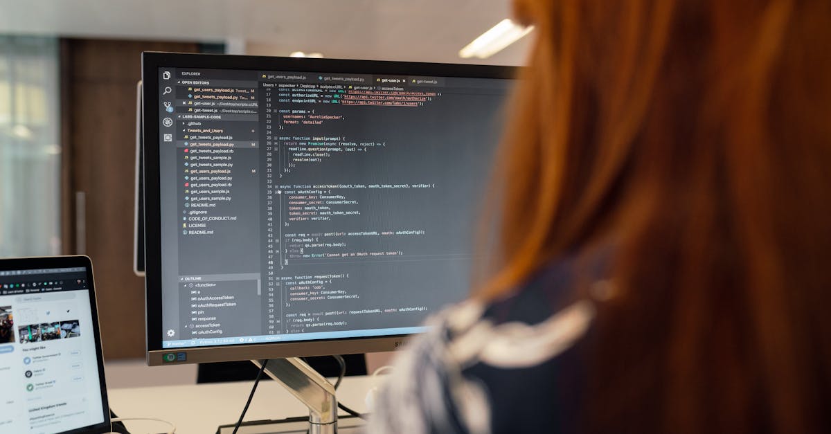 A female engineer works on code in a contemporary office setting, showcasing software development.
