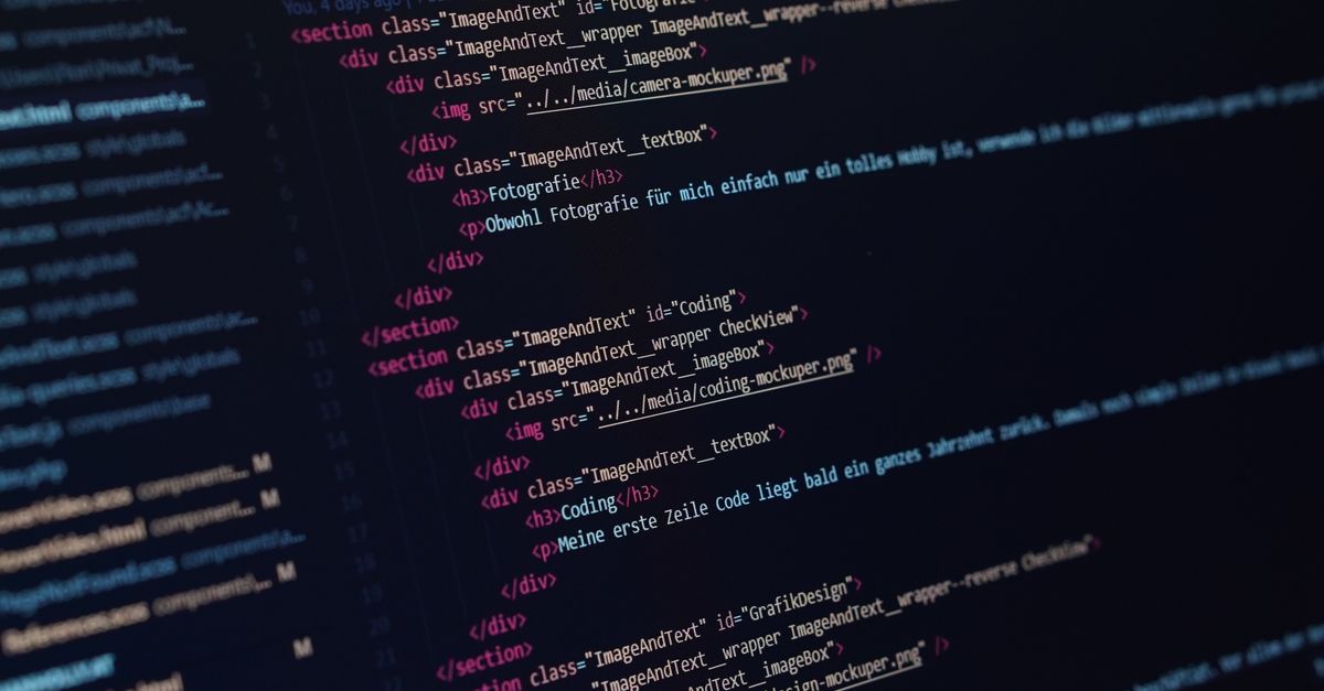 Close-up view of HTML code displayed on a dark screen, showcasing coding concepts.